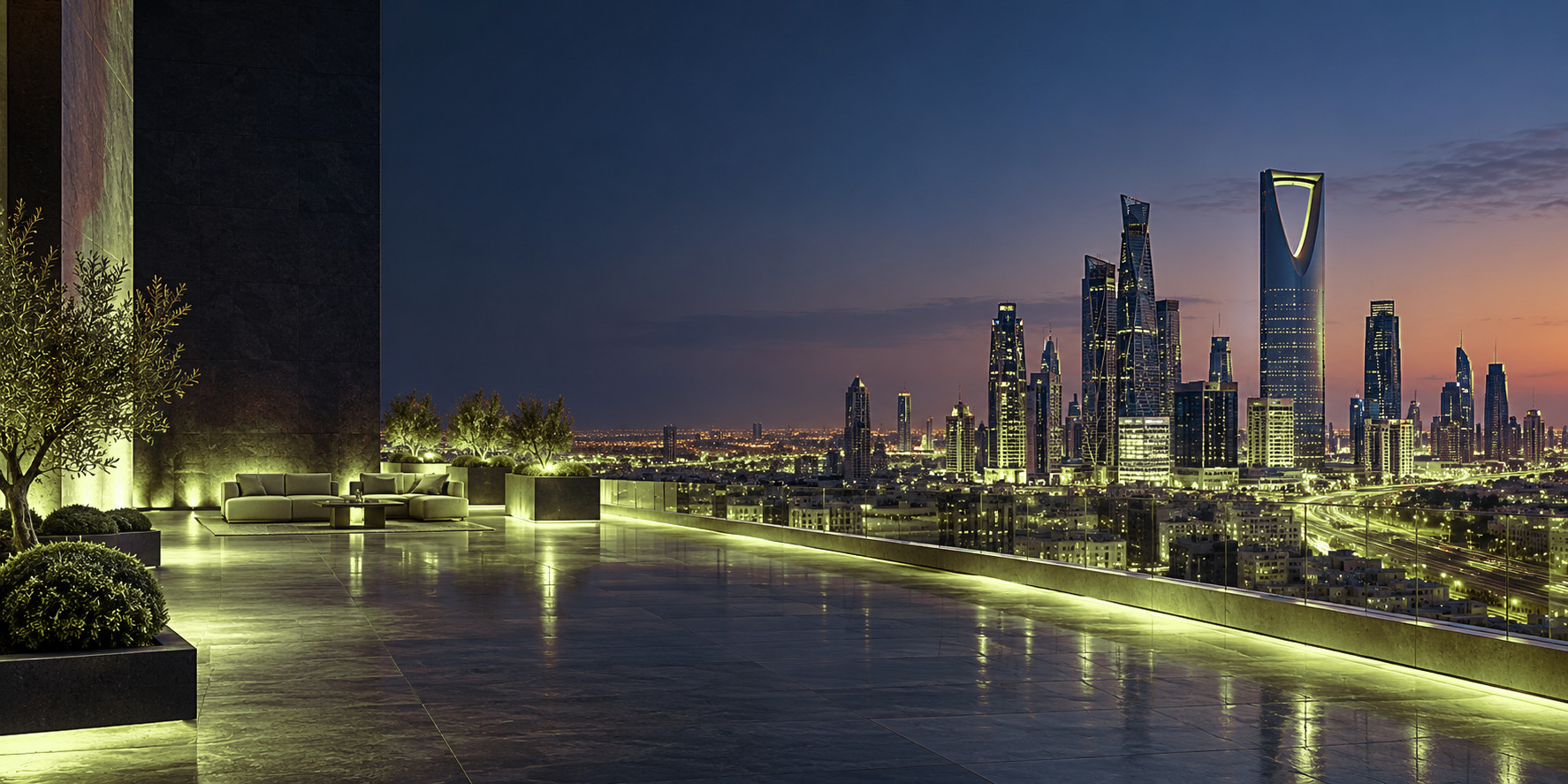 A lit rooftop terrace above Riyadh at dusk, the Kingdom Centre on the skyline